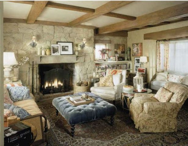 a neutral vintage space centered around a fireplace in a stone wall