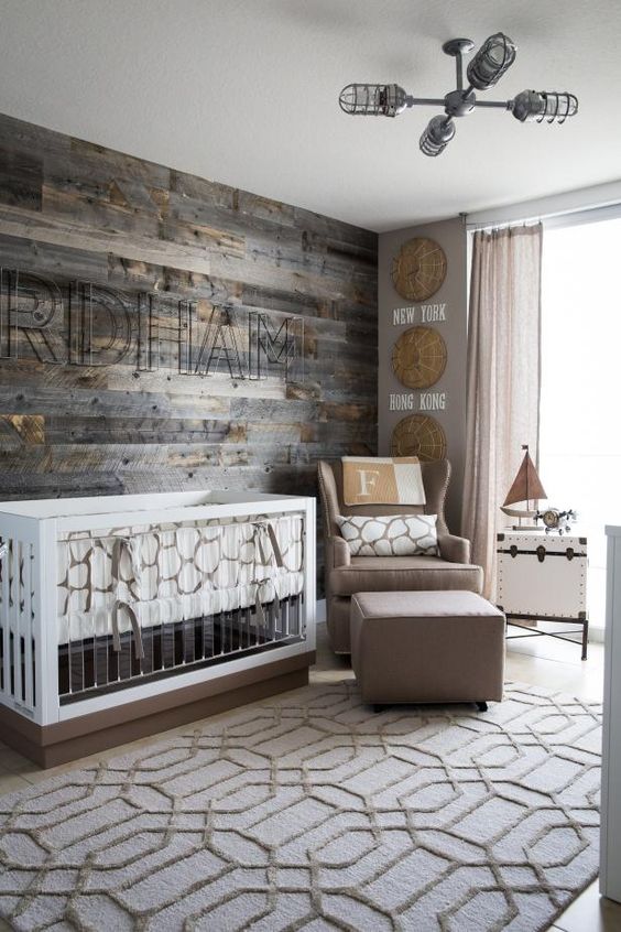 a rustic themed nursery with a reclaimed wood wall, burlap and wicker touches