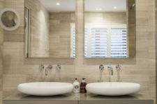 10 The master suite’s bathroom features a double sink vanity with matching wall mirrors and spotlights on the ceiling