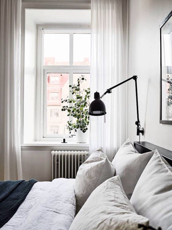 a black sconce is great for a Scandinavian or modern space with a simple color palette