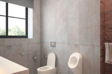 11 Raw concrete walls with brick ones can be seen in this part of the bathroom