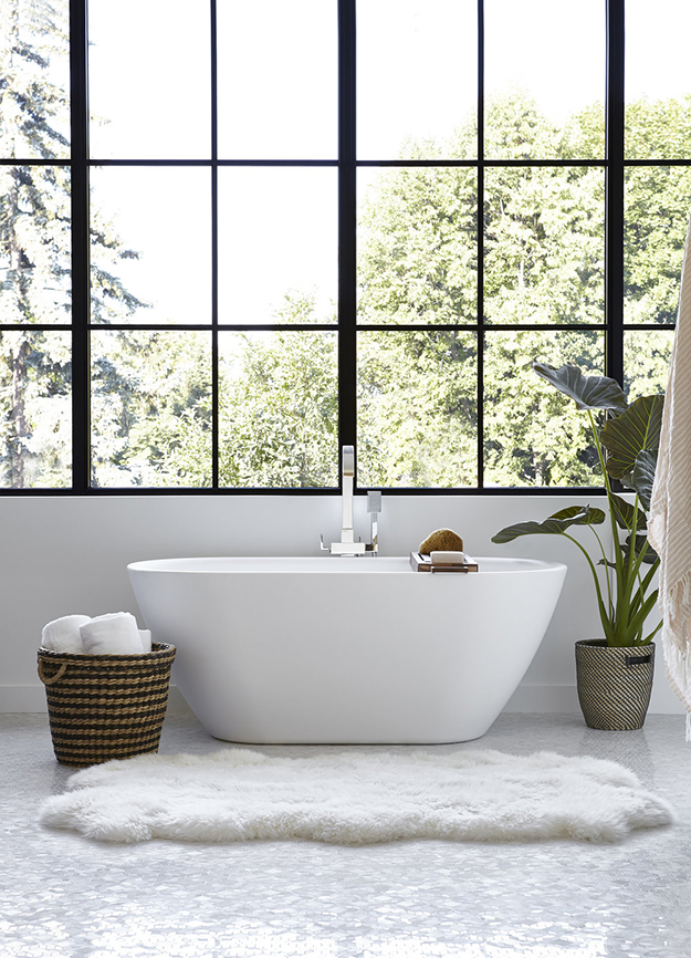The master bathroom features a free-standing bathtub and a glazed wall for cool views