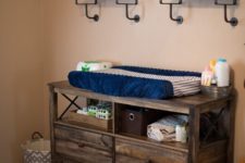 11 a dresser of reclaimed wood features open storage and can serve as a changing table