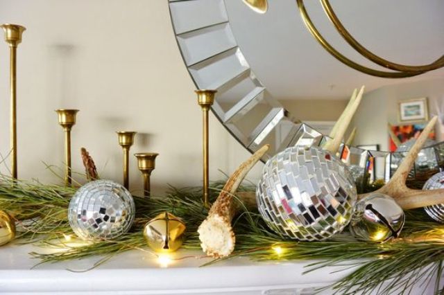 a glam mantel with a large mirror, shiny metal ornaments and LEDs