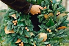 11 a gorgeous wreath of evergreens, acorns and magnolia leaves for a unique holiday decoration
