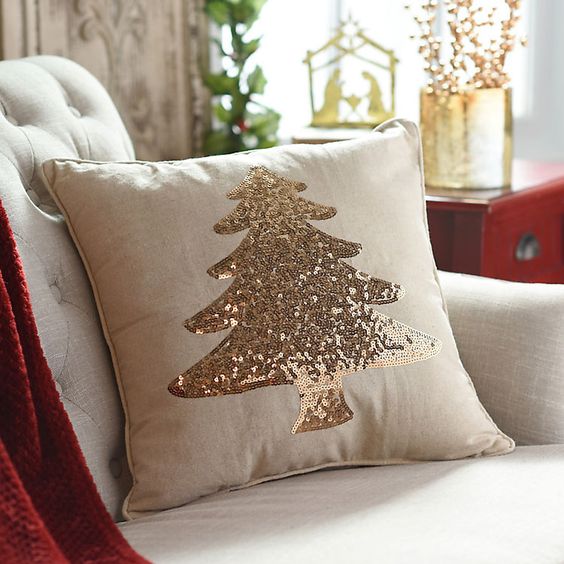 a neutral pillow with a champagne sequin Christmas tree looks very holiday-like