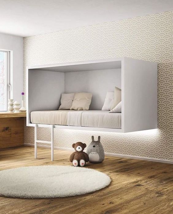 a unique white box suspended bed with a ladder for a minimalist kid's room