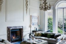 12 a built-in fireplace clad with marble makes this space special and cozy