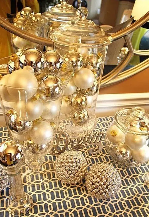 a festive gold and pearly ornament display in jars