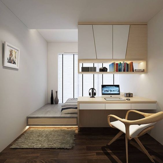 a minimalist desk with a suspended storage unit over it works as a space divider in this bedroom