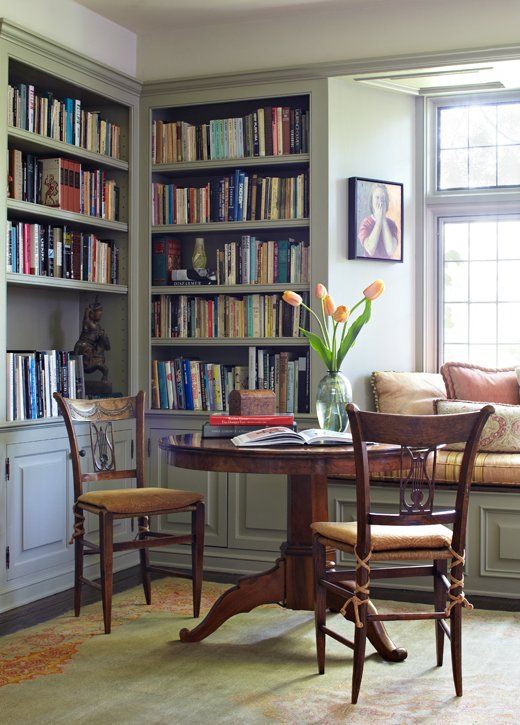 a vintage library space with a breakfast zone, vintage chairs and a pedestal table complete the look
