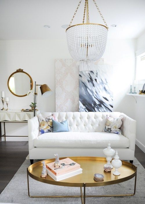 brass touches and a large crystal chandelier will give your space a glam feel