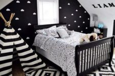 14 a black statement wall with a cloud print makes the space more eye-catching