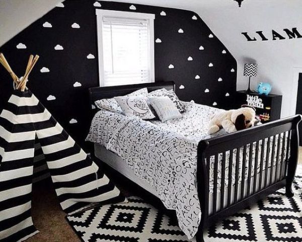A black statement wall with a cloud print makes the space more eye catching