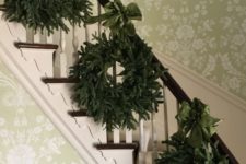 14 a trio of evergreen wreaths with emerald ribbon bows for decorating stairs
