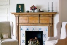 14 the fireplace is clad with blue and white tiles and wood in a seaside room