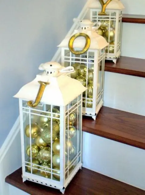 white lanterns filled with gold and gold glitter ornaments are great for marking the steps