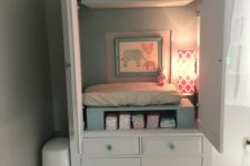 15 an armoire hides a changing table, storage and some additional light and makes the room look neat
