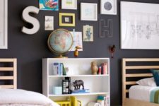 16 a black wall enlivened with colorful artworks and letters is great for any kids’ space