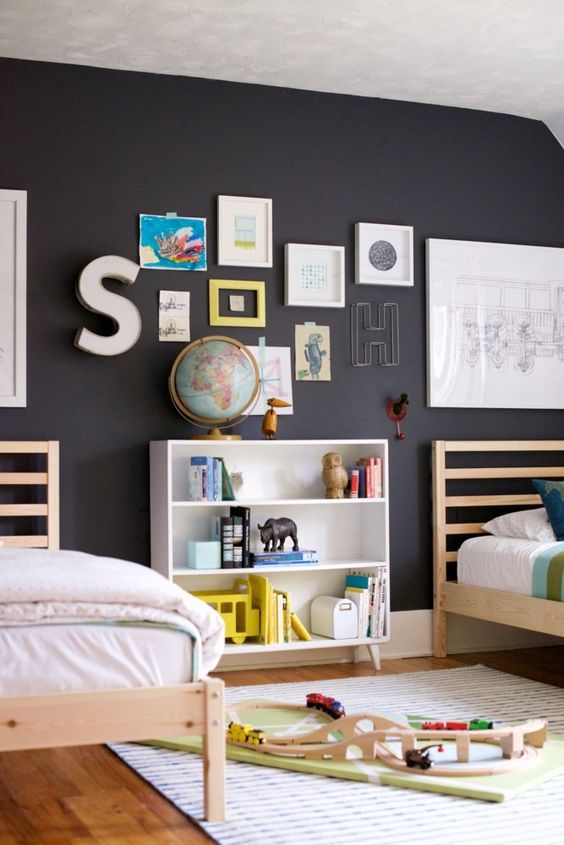 A black wall enlivened with colorful artworks and letters is great for any kids' space