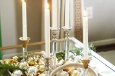 16 a chic Christmas centerpiece of candles, gold and silver ornaments is super easy to make yourself