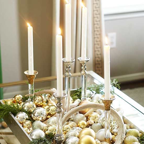 a chic Christmas centerpiece of candles, gold and silver ornaments is super easy to make yourself