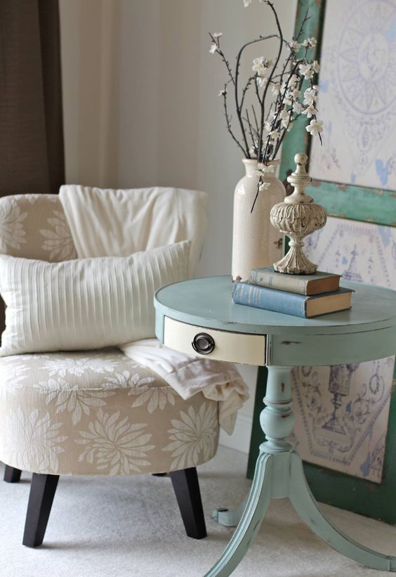 a light blue pedestal table with a drawer as a side table for a shabby chic space