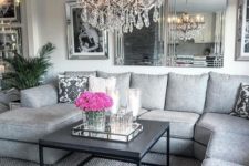 16 mirrors, mirror frames and a crystal chandelier spruce up the grey space