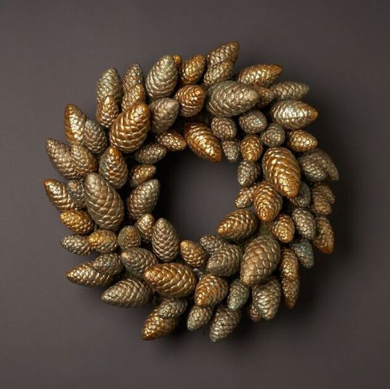 a Christmas wreath of gold pinecones looks glam and chic