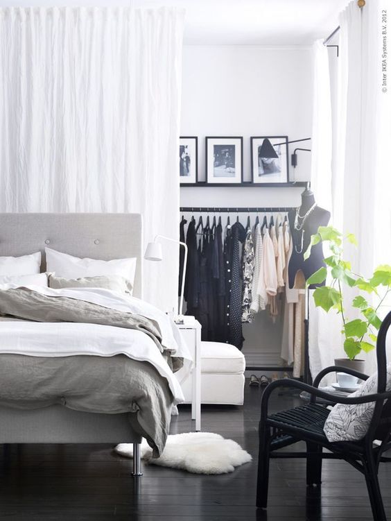 a Scandinavian space with a closet hidden behind the curtains is a perfect idea