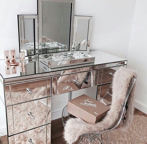 a mirror vanity and a three-part mirror on the vanity for a glam look