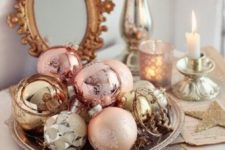 18 a tray with gold, copper, silver and pastel pink ornaments is a great holiday display