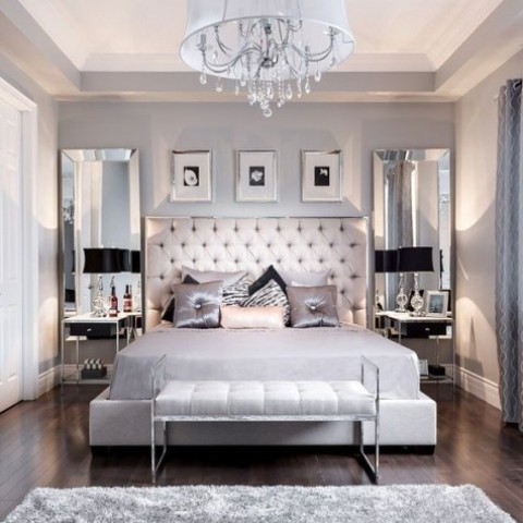 Large mirrors on the wall and shiny textiles make the bedroom glam like