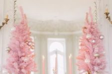 18 pink Christmas trees with pearly ornaments, mint ornaments and a gold garland for a glam mantel