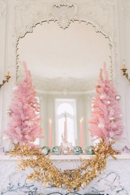 pink Christmas trees with pearly ornaments, mint ornaments and a gold garland for a glam mantel