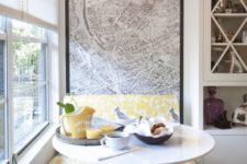 19 a modern bold breakfast nook by the window done in grey and yellow and with a map mural on the wall