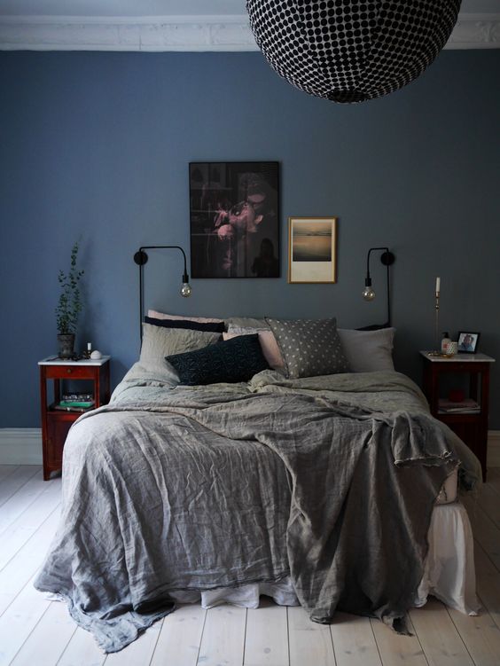simple black wall sconces with bulbs are great for different bedroom styles including eclectic