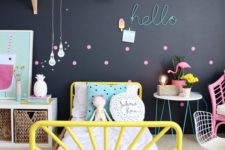 20 a colorful space is calmed down with a black statement wall, which is made more cheerful with bold accessories