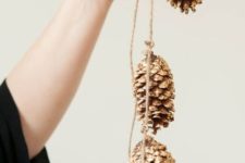 20 a gold pinecone garland is great for rustic and glam Christmas decor