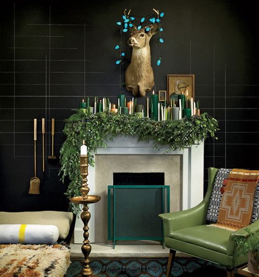 a lush evergreen garland and lots of candles in the shades of green and gold make an edgy look