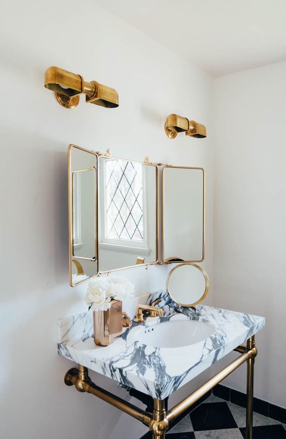 a marble vanity countertop, brass lamps, frames and legs for a vintage glam space
