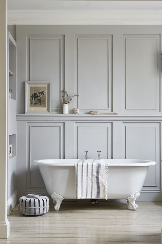 a neutral bathroom with grey paneled walls looks cool and refined
