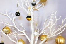 21 a fresh take on a Christmas tree – white branches, gold and black ornaments