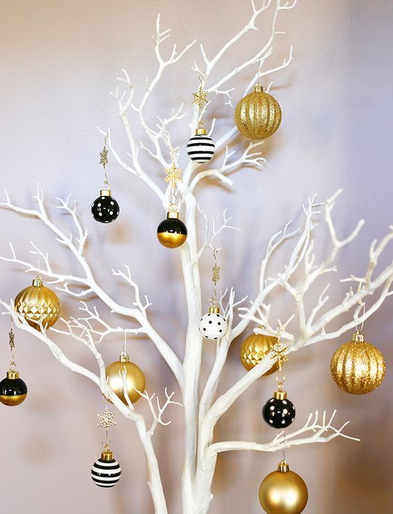 a fresh take on a Christmas tree - white branches, gold and black ornaments