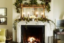 21 a lush evergreen garland with citrus, white blooms and a lush garland over the mantel