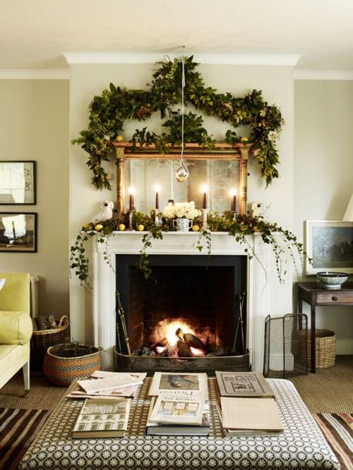 a lush evergreen garland with citrus, white blooms and a lush garland over the mantel