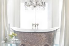 21 a shiny silver clawfoot bathtub and a glam chandelier over it will make your bathroom super cute