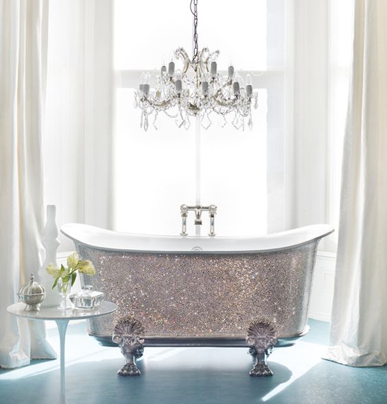 a shiny silver clawfoot bathtub and a glam chandelier over it will make your bathroom super cute