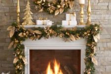 21 an evergreen and gold fruit and leaf garland and wreath for a holiday fireplace