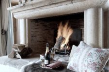 22 a gorgeous cozy nook at the fireplace, with faux fur and pillows to feel warm and comfy